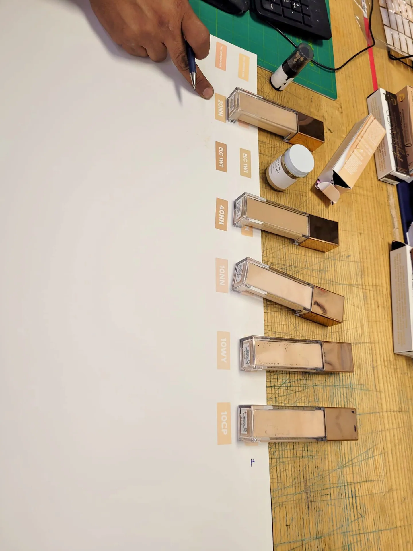 Checking printed label colours against a row of sample bottles